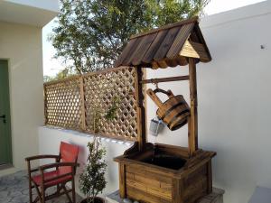 a water fountain in a wooden box on a patio at Harmony at Trifilianika in Trifilliánika