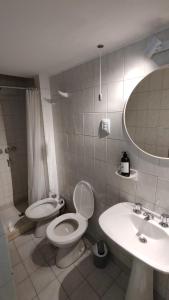 a bathroom with a toilet and a sink at La Escalerita- Estadio Kempes in Cordoba