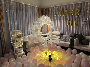 a living room with balloons and a sign that reads harare at Xu Xu Homestay in Chiayi City