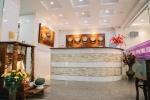 a lobby with a counter with clocks on the wall at HUNG HUONG HOTEL in Ho Chi Minh City