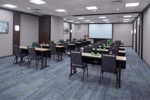 a conference room with tables and chairs and a screen at Courtyard New Haven at Yale in New Haven