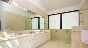 a large bathroom with two sinks and a shower at 15 Witta Circle in Noosa Heads
