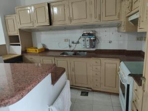 a kitchen with wooden cabinets and a counter top at happy home in Luxor