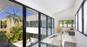 a large room with glass windows and a pool at 15 Witta Circle in Noosa Heads