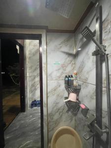 a bathroom with a marble wall with a toilet at Centralhome 2 in Plei Brêng