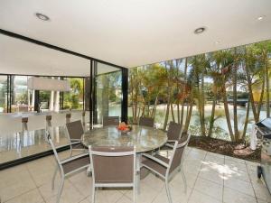 a dining room with a table and some chairs at Cascade, 15 Witta Circle, Noosa Heads in Noosa Heads