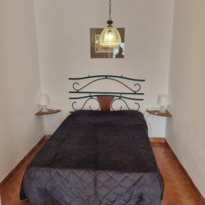 Un dormitorio con una cama con una manta negra. en Nelinha by Rosado, en Luz