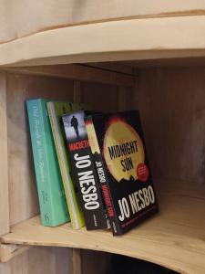 a group of books sitting on a shelf at Το σπιτάκι to spitaki Τhe little house in Panormos Kalymnos