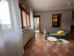 a living room with a couch and two tables at Casa Montessori in Avezzano