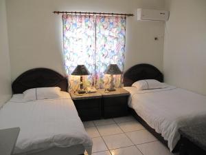 Postel nebo postele na pokoji v ubytování Capital Hotel