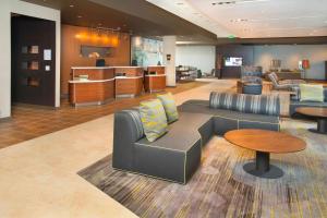 a lobby with a couch and a table at Courtyard by Marriott Redwood City in Redwood City