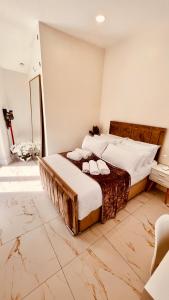 a bedroom with a large bed with marble floors at Cozy Charming Bungalow BRAND NEW in Preston