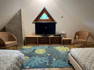 a living room with a tv and a window at Little Cottage No.100 in Vidochov