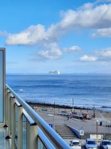 uma vista para o oceano a partir da varanda de um edifício em Sunny Beach Machico Apartment by HR Madeira em Machico