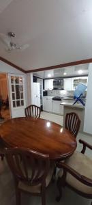 a wooden table and chairs in a kitchen at villa concha in Paipa