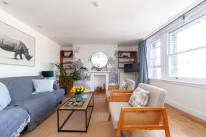 a living room with a couch and a table at Hub townhouse in London