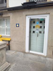 a door to a building with an umbrella on it at A Parada do Camiño Albergue y habitaciones privadas in Padrón