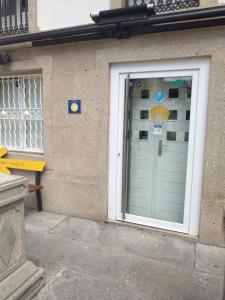 a door to a building with an umbrella on it at A Parada do Camiño in Padrón