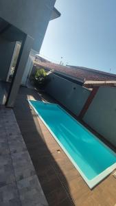 a swimming pool on the side of a house at Sobrado com 3 quartos piscina 100m mar em matinhos in Matinhos