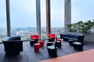 a room with chairs and couches in a building at Millerz Cozy Home by GUESTONIC in Kuala Lumpur