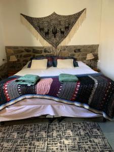 a bedroom with a large bed with a canopy at Cabaña Los Girasoles Cachi Salta in Cachí