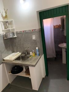 a kitchen with a sink and a counter top at Cabaña Los Girasoles Cachi Salta in Cachí