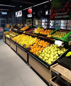 a produce section of a grocery store with fruits and vegetables at Sava centar-Stark Arena lux apartman Ema in Novi Beograd