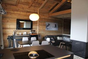 a kitchen and dining room with a table and chairs at Chalet Niyama in Font-Romeu-Odeillo-Via