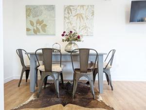 a dining room table with chairs and a vase of flowers at The Gofflet, Petworth in North Chapel