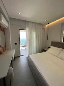 a bedroom with a bed and a view of the ocean at Villa Idrizi in Sarandë