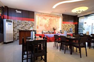 a restaurant with tables and chairs and a map on the wall at Eurotel Makati in Manila