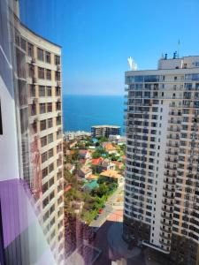 a view of the ocean from a building at Odessa arkadiya 4 room and Jacuzzi Lux in Odesa