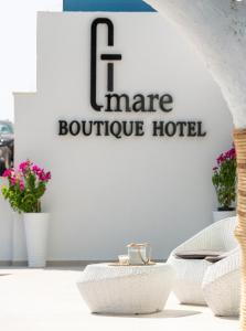 a store with a sign that reads more boutique hotel at G Mare Boutique Hotel in Neos Marmaras