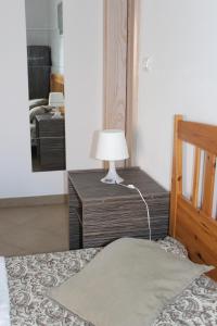 a bedroom with a bed with a lamp on a table at Studio Lavanda in Kornić, Krk in Kornić