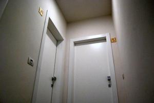un pasillo con una puerta blanca en una habitación en Guest House Zefiro, en Florencia