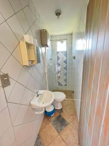 a bathroom with a toilet and a sink at Chales Sitio dos Ventos in Lavras Novas