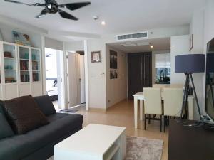 a living room with a couch and a table at Centara Avenue 2 Bedrooms Pool View in Pattaya Central