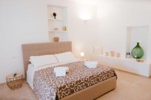 Ένα ή περισσότερα κρεβάτια σε δωμάτιο στο Iconica Luxury Suites