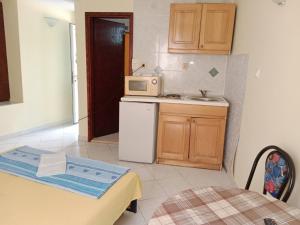 a small kitchen with a sink and a microwave at Vila Sisevic in Budva