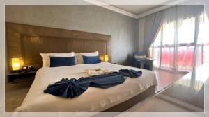 Un ou plusieurs lits dans un hébergement de l'établissement Hotel Al Massira