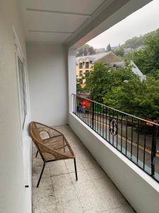 a wicker chair sitting on a balcony with a view at Hillview in Oban