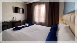 Un ou plusieurs lits dans un hébergement de l'établissement Hotel Al Massira