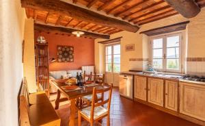 una cucina e una sala da pranzo con tavolo e sedie di Podere Argena a Lucignano