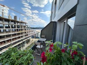 een balkon met bloemen en een bank op een gebouw bij Rybalsky Studio apartment Dnipro view in Kiev