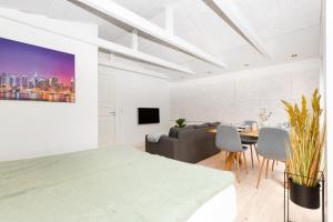 uma sala de estar branca com um sofá e uma mesa em Idyllisk lejlighed med plads til 4-personer em Højbjerg