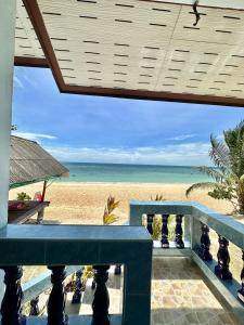 a view of the beach from the balcony of a resort at Euphoria Bungalow in Haad Yao