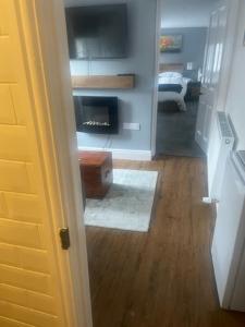 a hallway with a living room with a fireplace at White House in Carlisle