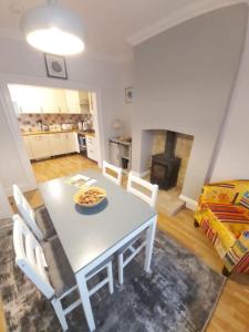 a kitchen and dining room with a table and chairs at Charming 2 double bed cottage style house in Bristol