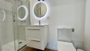 a bathroom with a toilet and a sink and a mirror at L'Escale in Fort-Mahon-Plage +4 photos