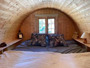 a bedroom with a large bed in a log cabin at Lagarta , la buche in Étival